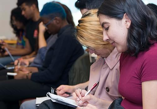 Students taking notes in an event